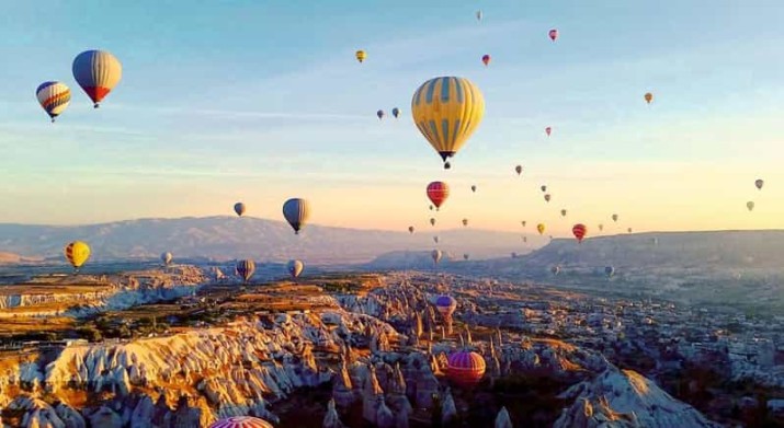 Take a magical ride with fairy chimneys hot air balloon in Cappadocia, soaring above breathtaking rock formations and enjoying the stunning sunrise